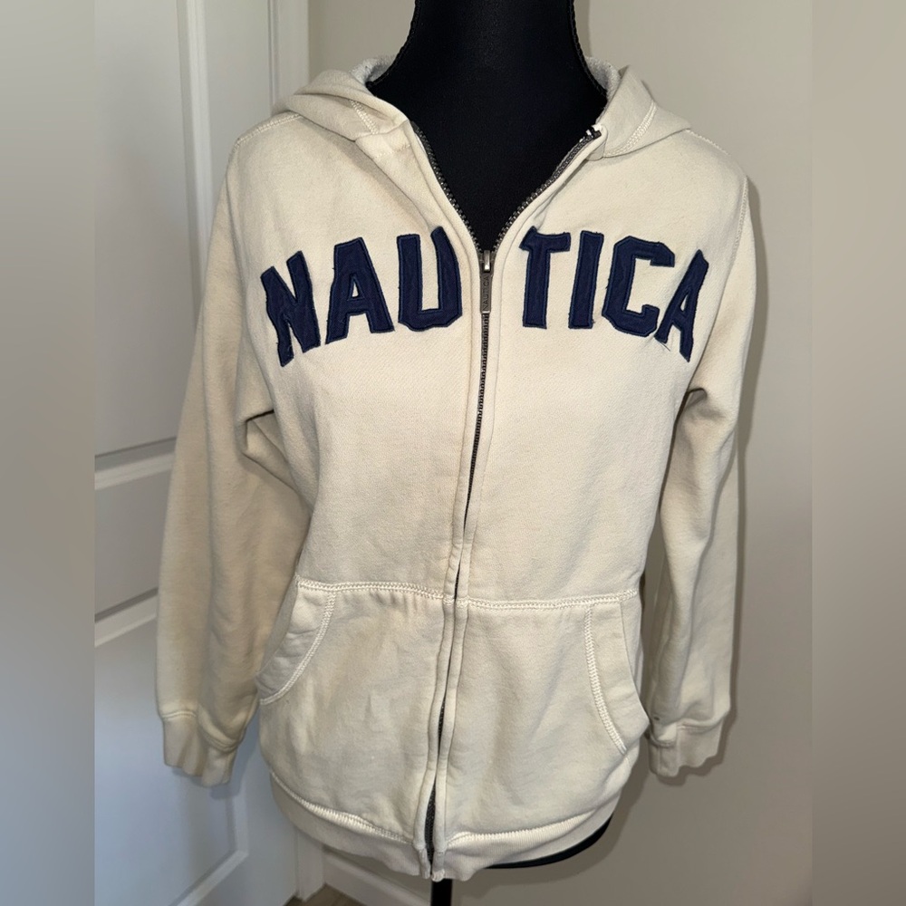 Cream Nautica Hoodie with bold, stitched, navy “NAUTICA” lettering across the ch